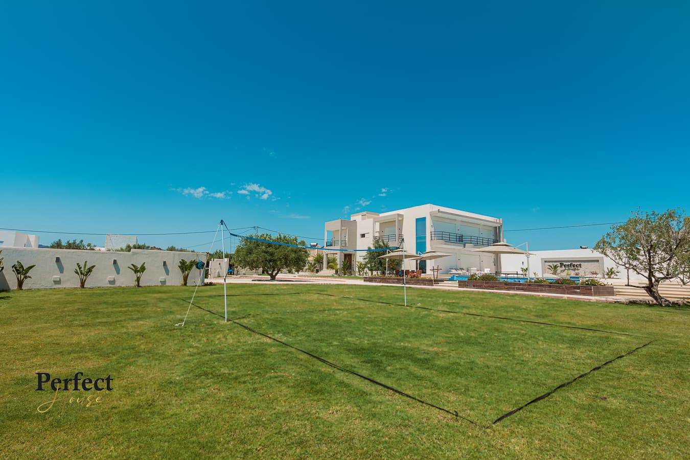 Perfect House Villa grounds and outdoor pool by day